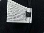 Black clothing tag label inside the neckline with care instructions.