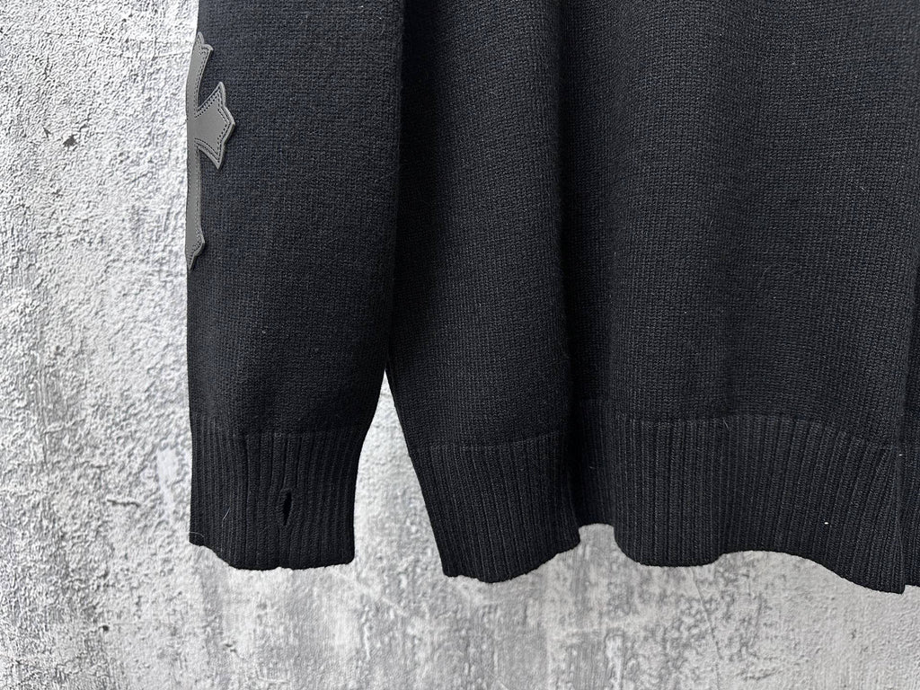 Black knit sweater sleeves with ribbed cuffs and hem.