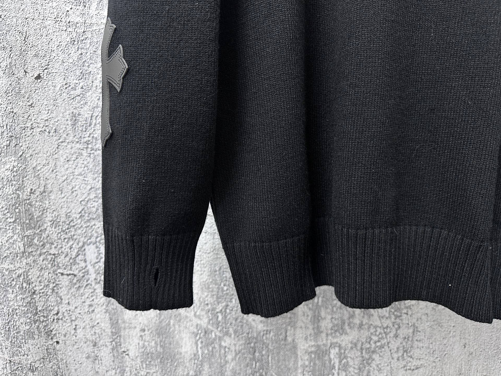 Black knit sweater sleeves with ribbed cuffs and hem.