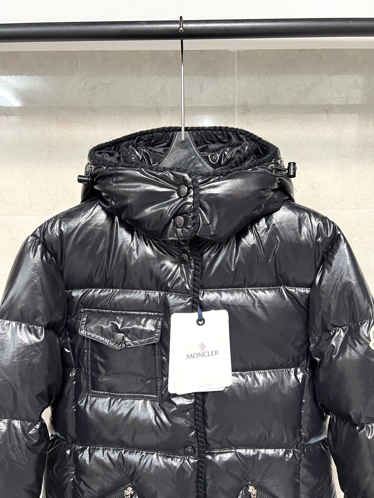 Moncler long puffer jacket, glossy black hooded puffer with front zipper and hanging tags
