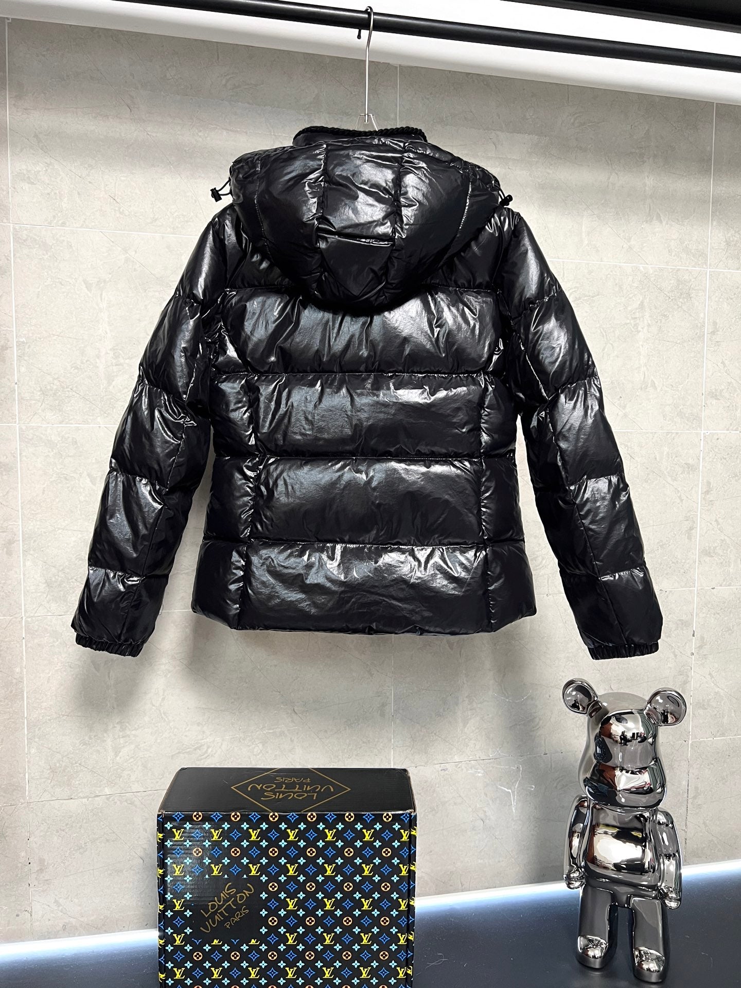 Moncler long puffer jacket, glossy black with raised hood and horizontal quilting
