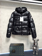 Moncler long puffer jacket in glossy black with hood, front zip and side pockets