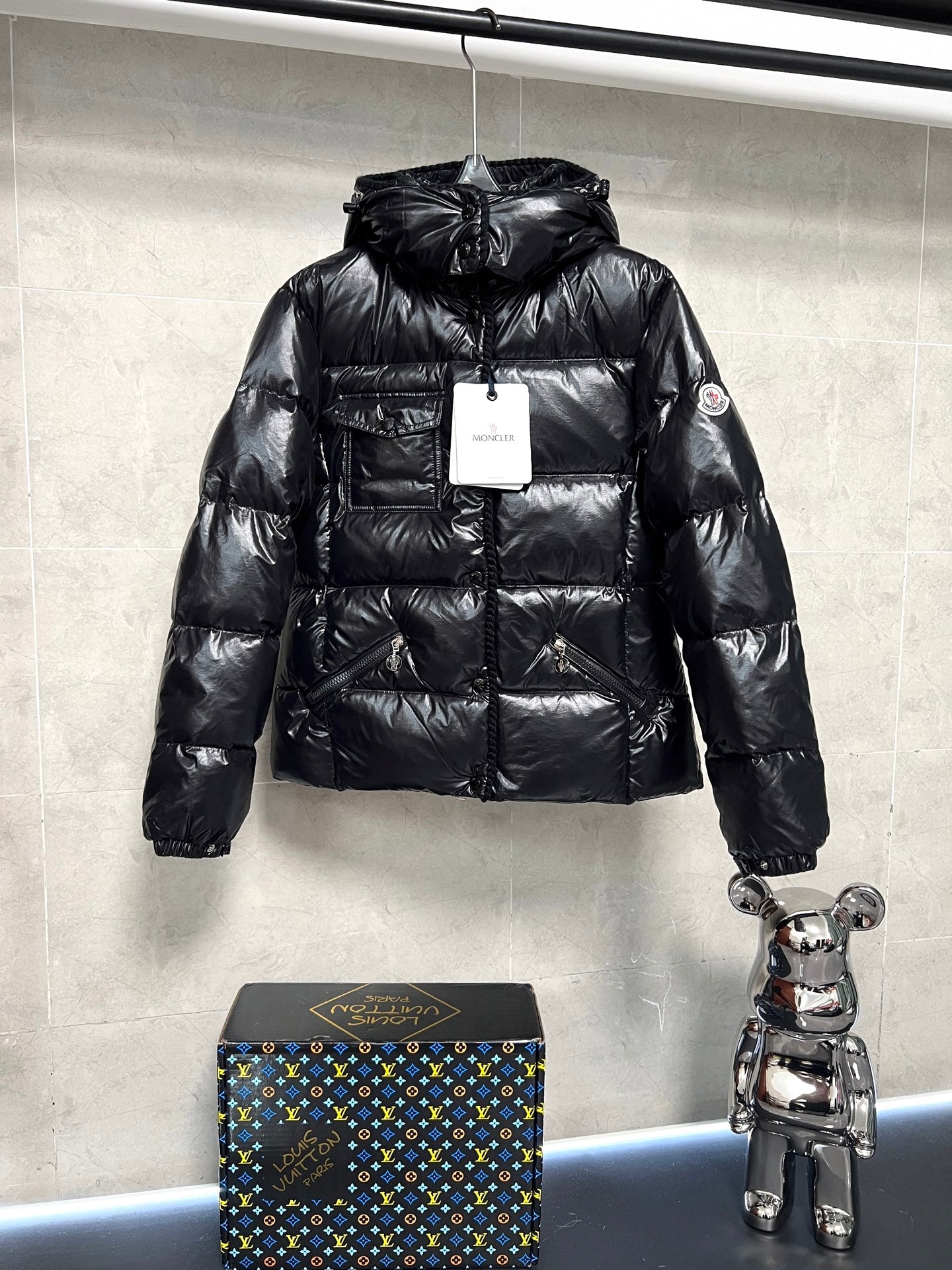 Moncler long puffer jacket in glossy black with hood, front zip and side pockets