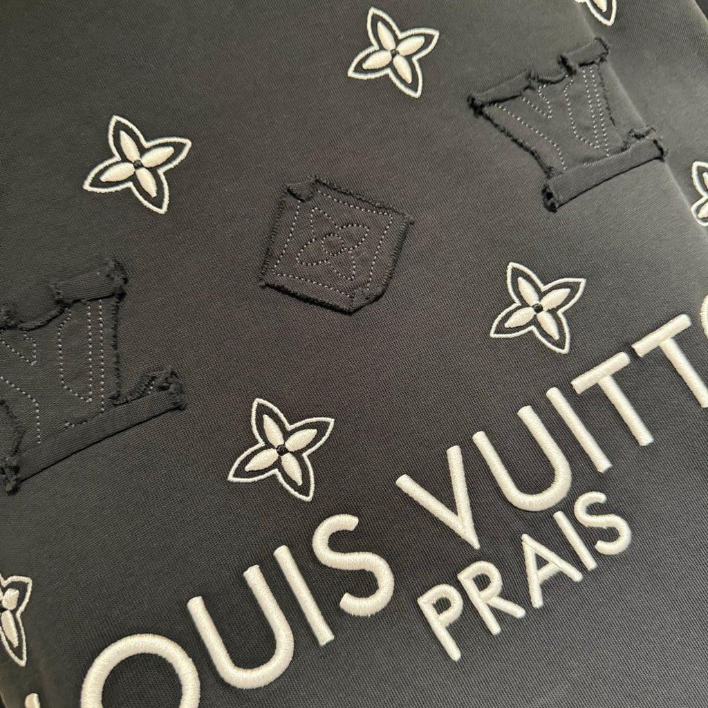 Louis Vuitton short-sleeve T-shirt detail, white floral print and “PRAIS” text