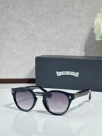 Chrome glasses with black round frames and purple-gray tinted lenses