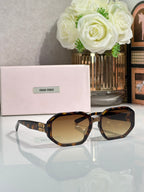 Oversized square sunglasses with tortoise frame and amber-tinted lenses, Miu Miu logo.