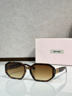 Square sunglasses with tortoise frame and amber-tinted lenses, featuring Miu Miu logo.