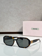 Square sunglasses with tortoise-accent frame, dark tinted lenses and Miu Miu logo on temple.