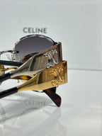 Celine sunglasses with gold frame and dark tinted lens close-up