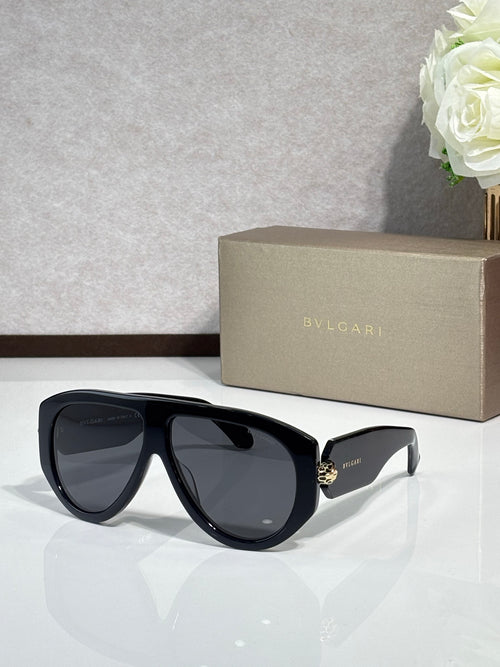 Black cat-eye sunglasses with dark smoke lenses and gold logo detail