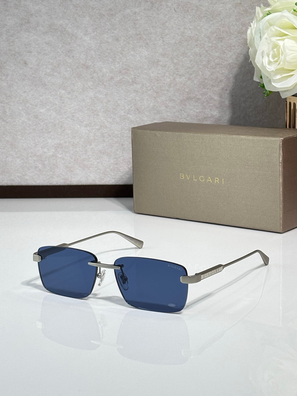Sunglasses with blue lenses, metal frame with black and gold-tone arms