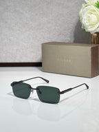 Sunglasses with dark green lenses, metal frame with black and gold-tone arms