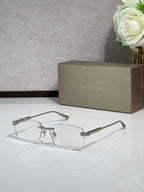 Metal eyeglass frames with clear lenses, gold-tone rectangular design and top bar
