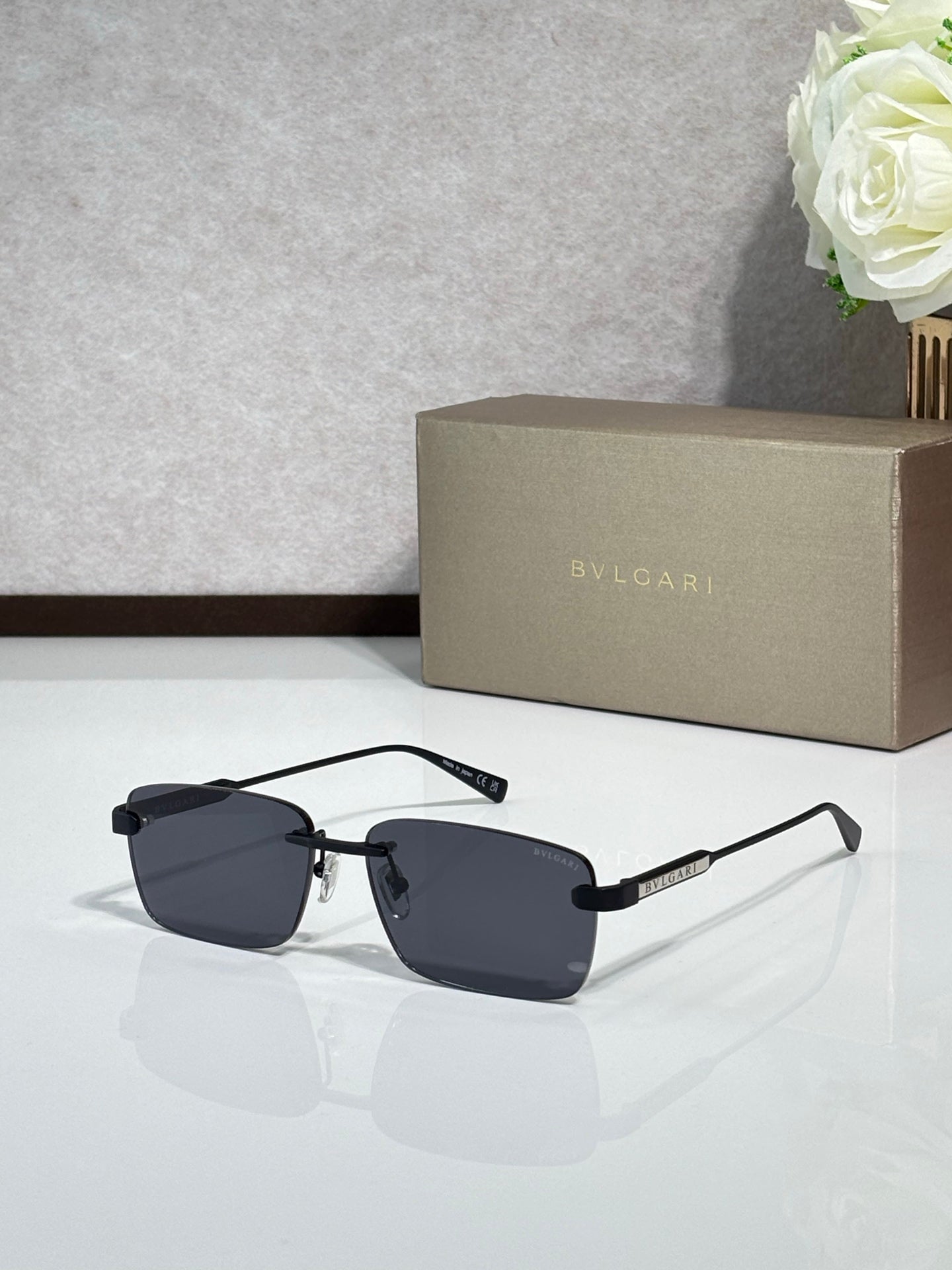 Sunglasses with dark lenses, metal frame with black and gold-tone arms