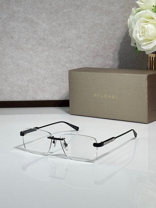 Metal eyeglass frames with clear lenses, black and gold-tone rectangular design