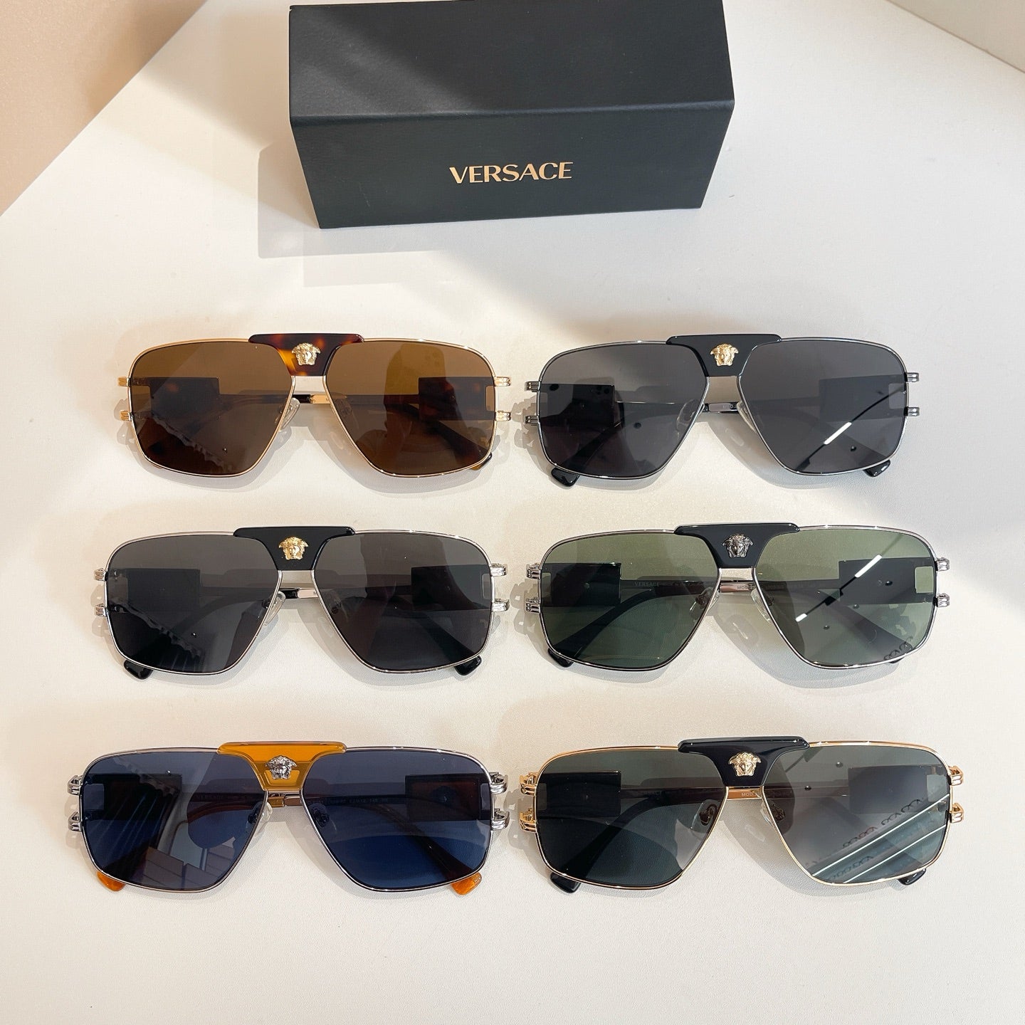 Versace sunglasses set with multiple pairs and tinted lenses, plus assorted metal frames