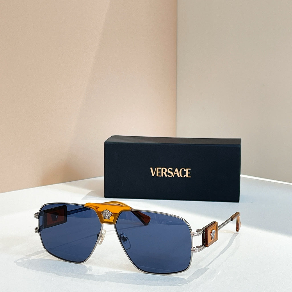 Versace sunglasses with blue lenses, gold frame, and amber center logo detail