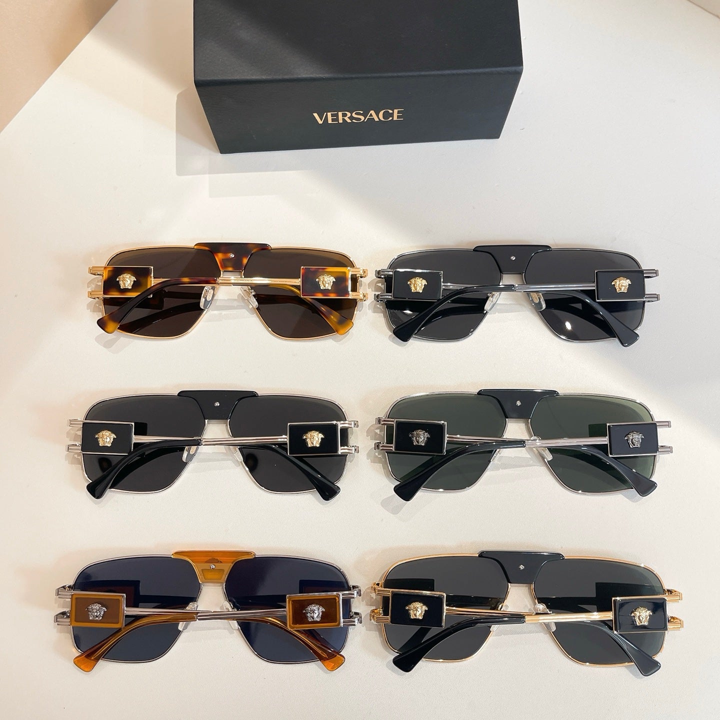 Versace sunglasses set showing six pairs with tinted lenses and black or gold frames