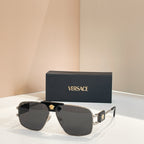 Versace sunglasses with dark lenses, silver frame, and gold logo detail on top bar
