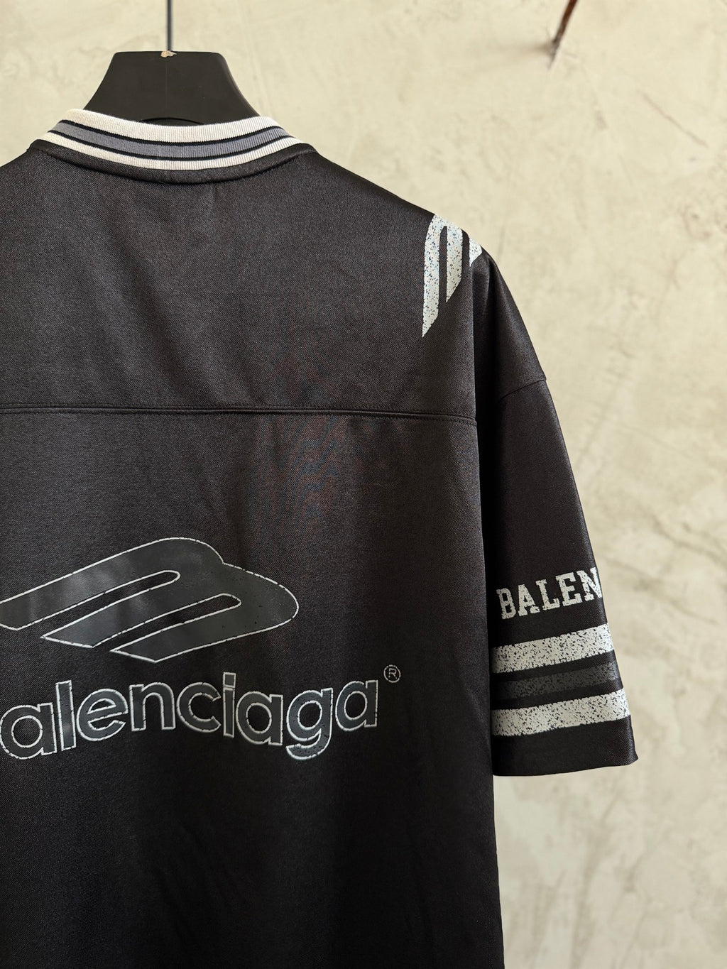 Balenciaga black polo shirt back view with striped collar and sleeve graphic
