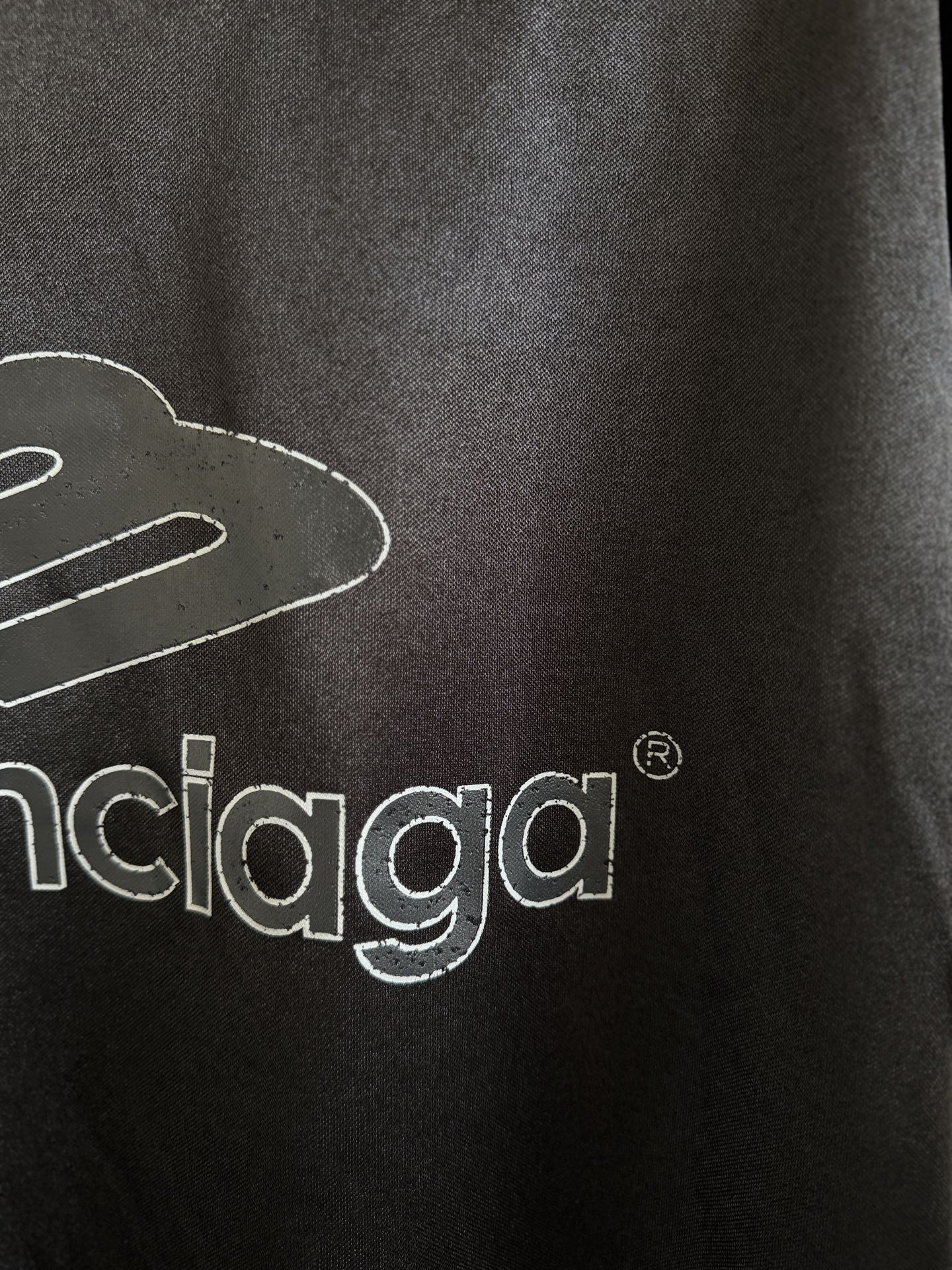 Balenciaga black polo back close-up with balenciaga logo lettering
