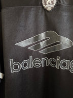 Black Balenciaga polo shirt with large 'balenciaga' logo across the chest
