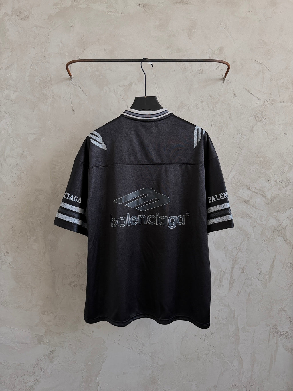 Black short-sleeve polo shirt with striped cuffs and Balenciaga logo on back