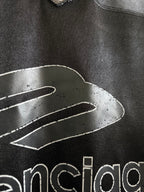 Black Balenciaga polo shirt with outlined graphic and partial 'balenciaga' logo