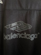 Black Balenciaga polo shirt with large 'balenciaga' logo print