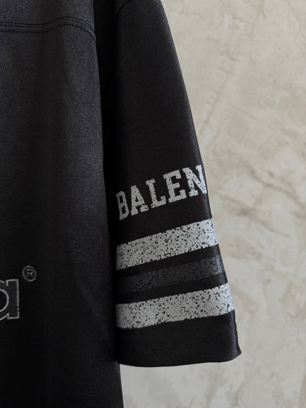 Balenciaga black polo sleeve with BALENCIAGA text and two stripe bands