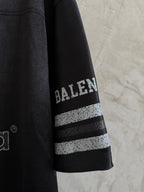 Balenciaga black polo sleeve with BALENCIAGA text and two stripe bands