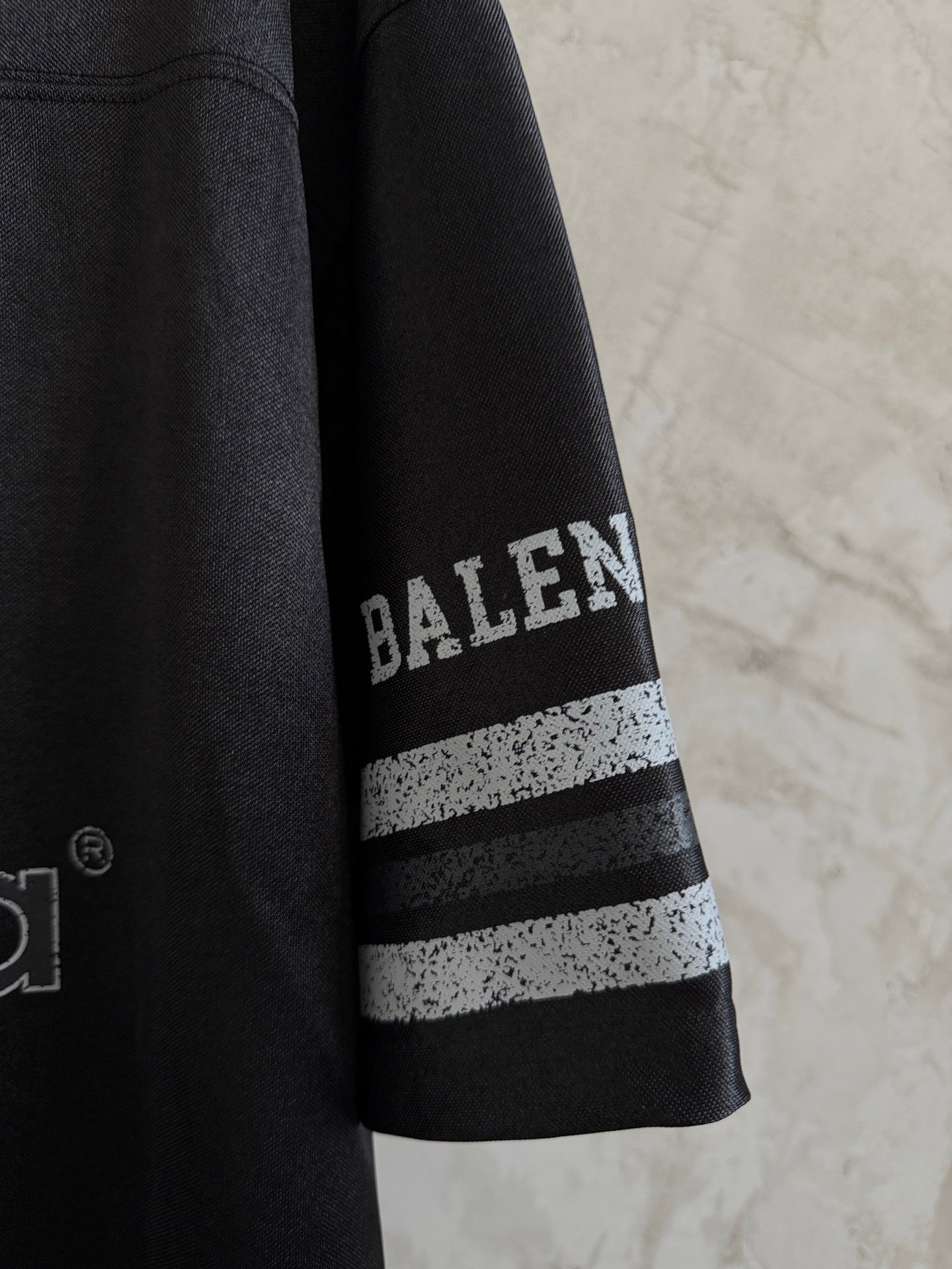 Balenciaga black polo sleeve with BALENCIAGA text and two stripe bands