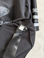 Black Balenciaga polo shirt with neck label tag and draped sleeve