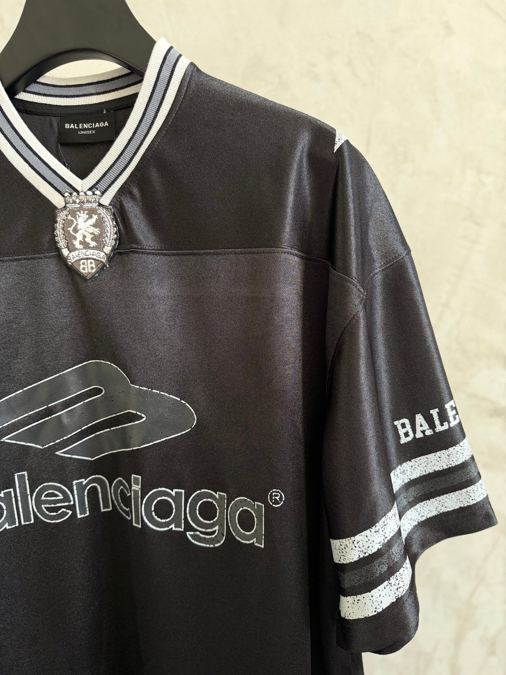 Black Balenciaga polo shirt with crest at collar and striped cuff on sleeve
