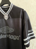 Black Balenciaga polo shirt with crest at collar and striped cuff on sleeve