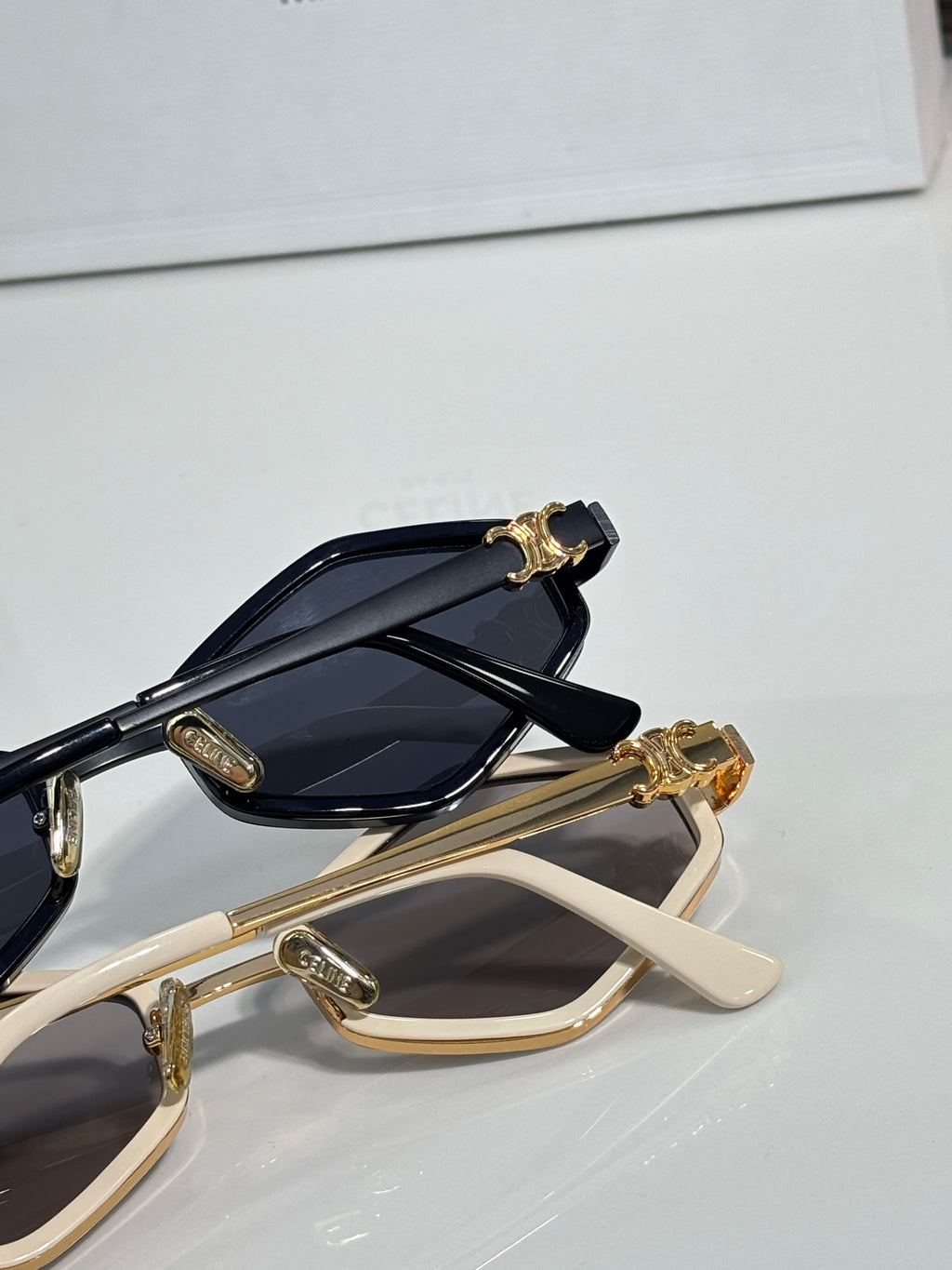 Celine gold and beige sunglasses close-up with dark lenses and ornate temple charm