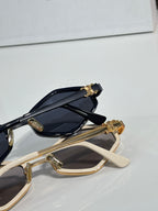 Celine gold and beige sunglasses close-up with dark lenses and ornate temple charm