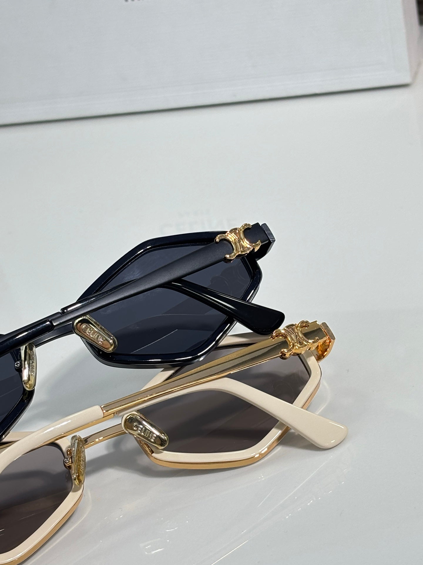 Celine gold and beige sunglasses close-up with dark lenses and ornate temple charm