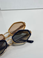 Celine gold and navy sunglasses close-up with dark lenses and gold temple details