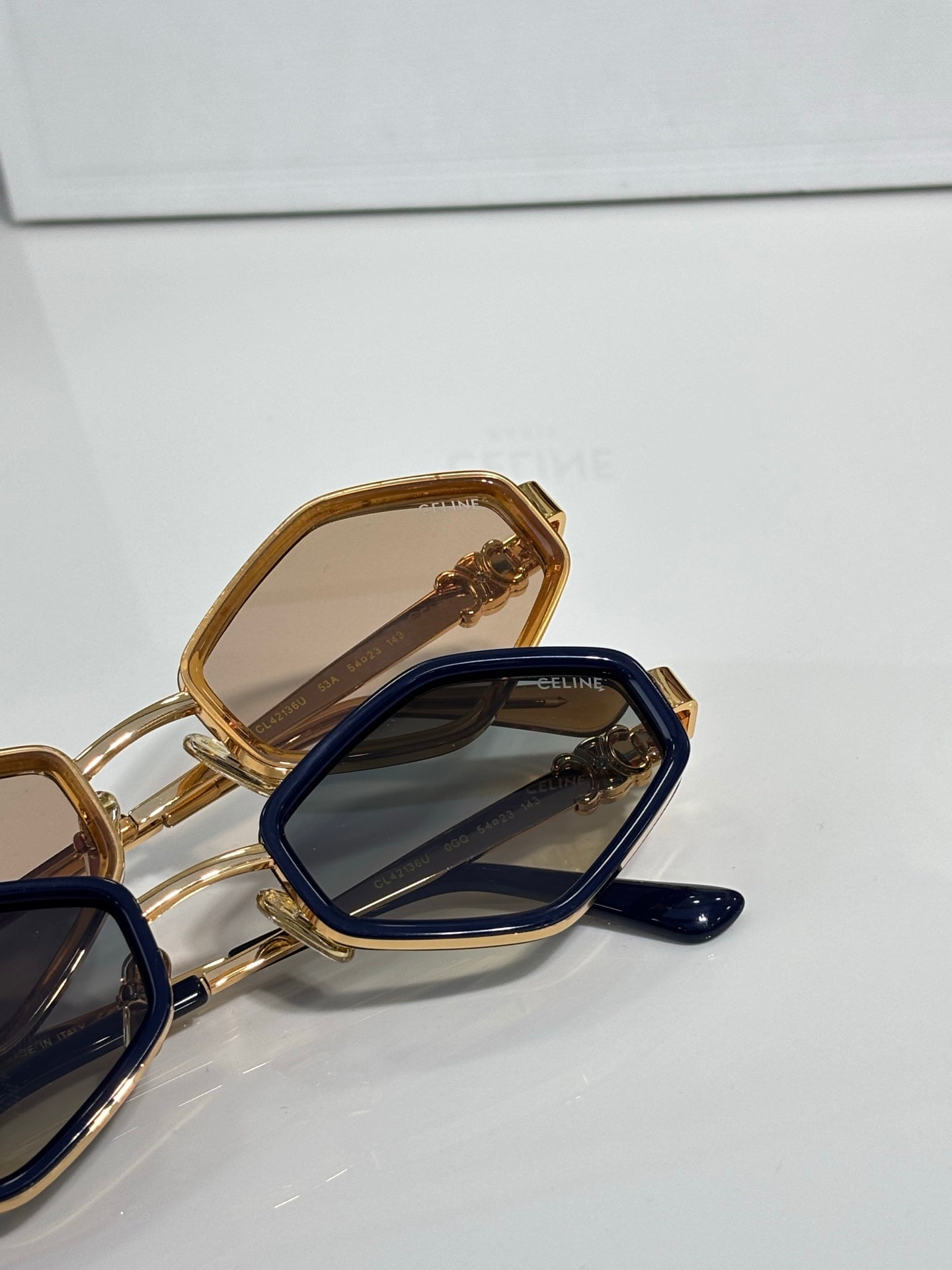 Celine gold and navy sunglasses close-up with dark lenses and gold temple details