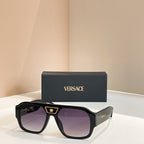 Versace sunglasses with black frames and purple-tinted lenses