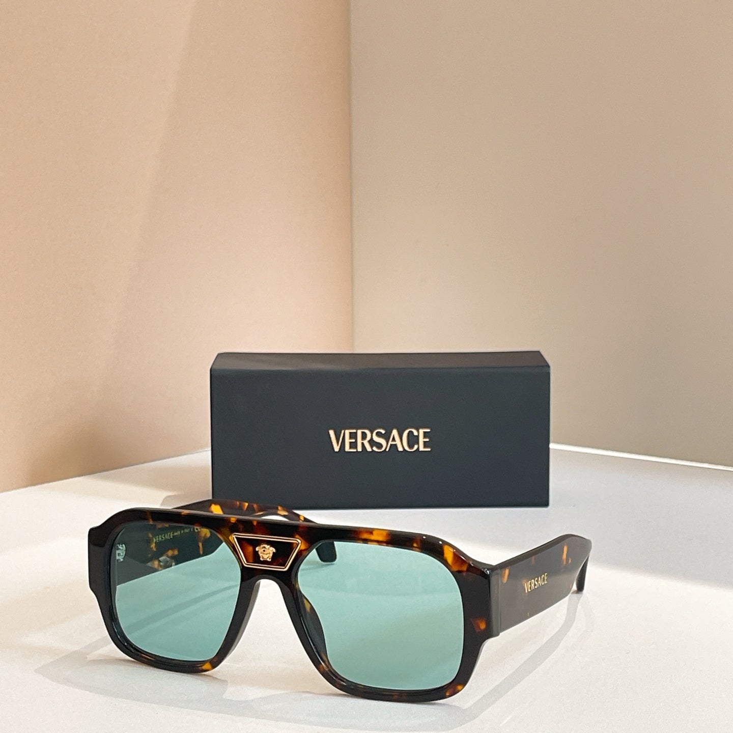 Versace sunglasses with tortoiseshell frames and green-tinted lenses
