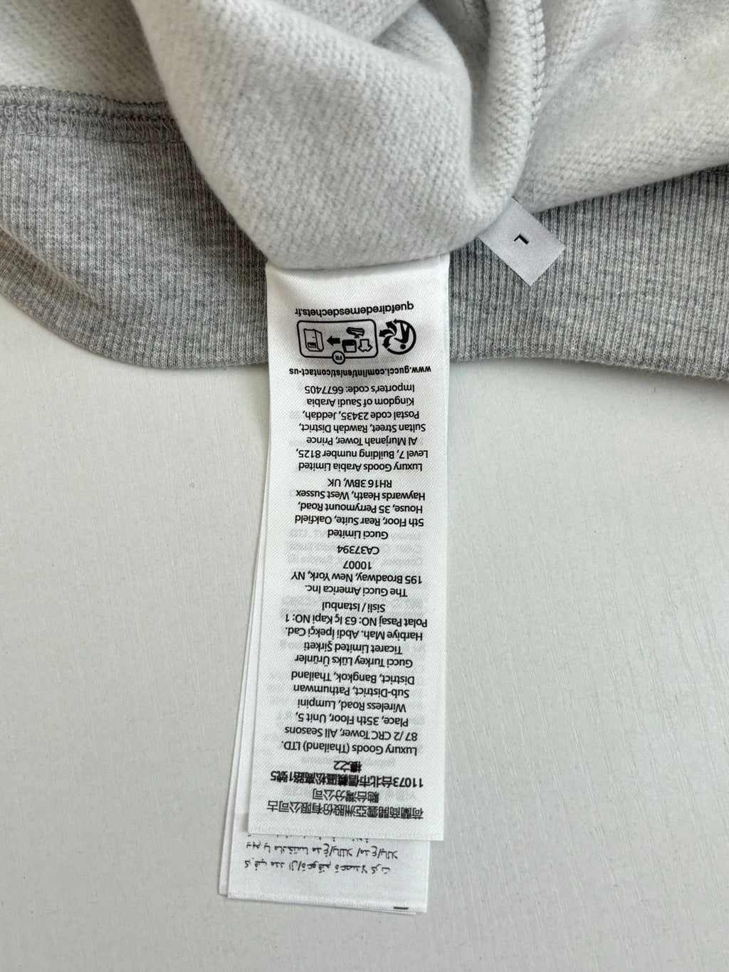 Light gray sweatshirt neckline care label and inner collar seam