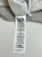 Light gray sweatshirt neckline care label and inner collar seam