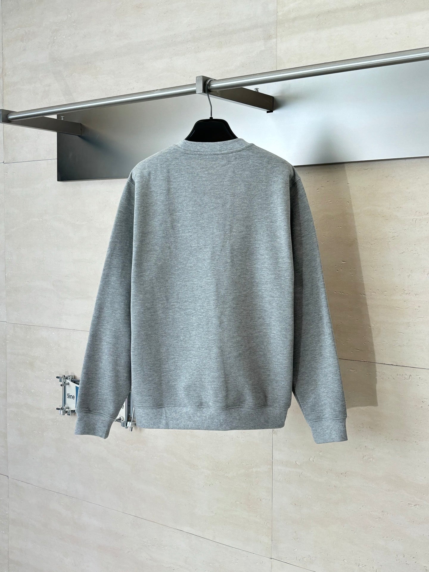 Light gray long-sleeve sweatshirt, back view with crew neck and no front print