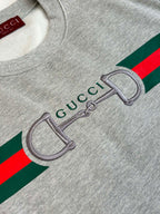 Light gray sweatshirt graphic close-up with green and red stripe and Gucci detail