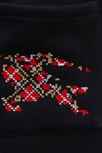 Black pants with large pixel-style red, gold, and beige embroidered emblem
