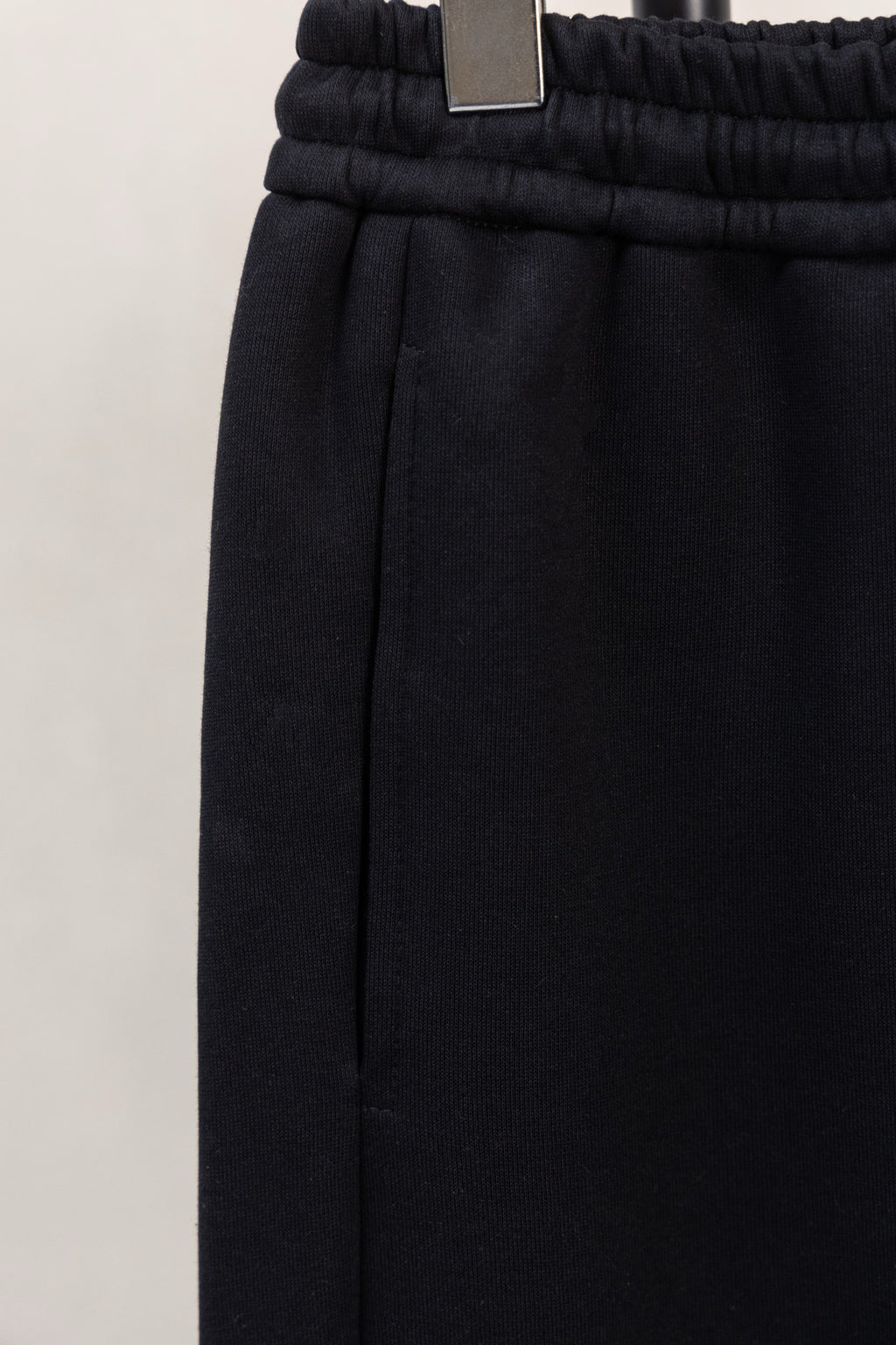 Black elastic-waist pants with straight leg and stitched side seam