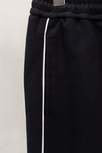 Black pants with elastic waistband and white drawstring ties