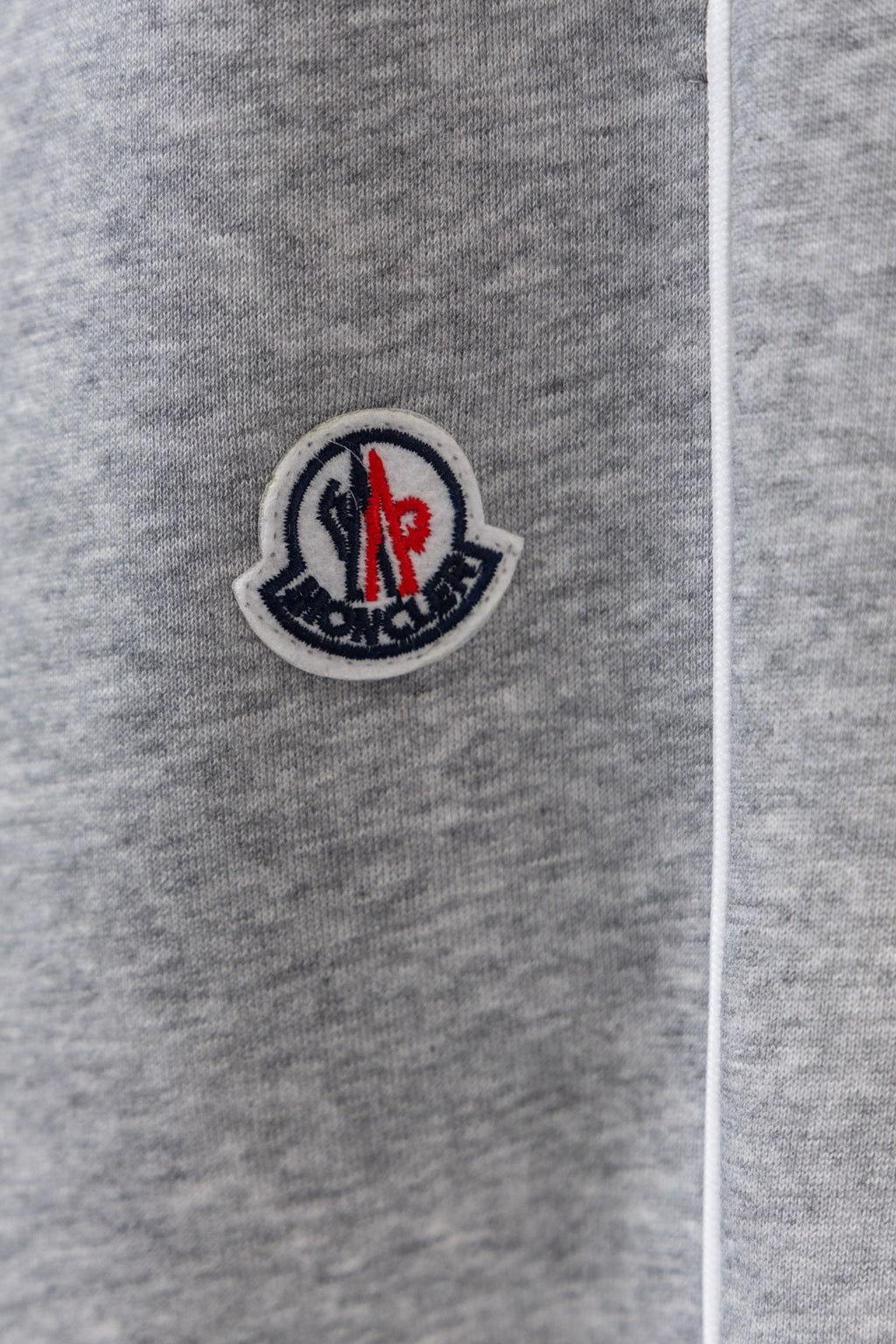 Moncler sweatpants leg with circular logo patch and drawstring cord